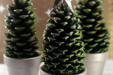 large pinecones painted green, in silver planters and topped with silver stars are great alternative tabletop Christmas trees