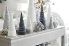 white, grey and graphite grey velvet cord cone Christmas trees styled with LED lights and snowy pinecones