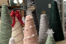 yarn cones wrpaped with pompoms and threads, topped with stars, snowflakes, bows and other stuff are simple and cool Christmas trees