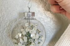 04 a clear glass Christmas ornament filled with baby’s breath is a lovely idea for boho Christmas decor