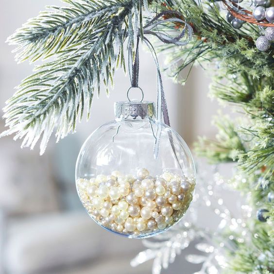 a clear glass Christmas ornament filled with pearls is a glam and chic idea with a vintage feel