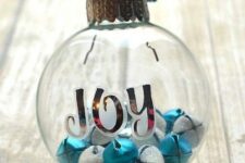09 a clear glass Christmas ornament with letters, white glitter and blue bells is a fun and cool way to add color to your Christmas tree