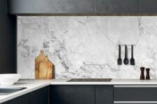 12 a black minimalist kitchen with sleek cabinets, neutral stone countertops and a white marble backsplash