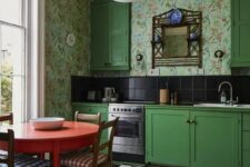 12 a bold vintage kitchen with bright green cabinets, bright floral wallpaper, black tiles on the backsplash, a checked floor and a round red table