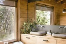 12 a contemporary bathroom fully clad with wood, with a large mirror, a wooden vanity and a window for a cool view