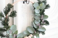 13 a Scandinavian Christmas wreath with evergreens, eucalyptus and wooden beads is a lovely decoration