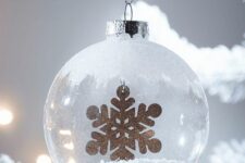 13 a frosty glass Christmas ornament with faux snow inside and a touch of frost on top plus a gold snowflake