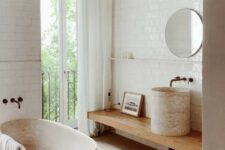 15 a contemporary bathroom with a wooden floor, a wooden tub, a wooden vanity and a stone sink plus white subway tiles