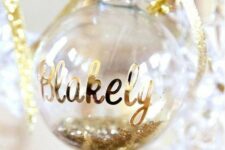 15 a glitter filled ornament with a name and a bow will be a perfect Christmas gift tag that you can easily make yourself