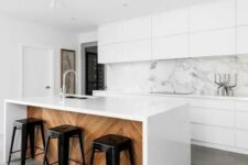 15 sleek white cabinets and a white marble backsplash that makes the whole space very exquisite and edgy