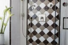 17 a bright shower space clad with geometric tiles and a bold monochromatic arabesque tile accent is super cool