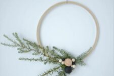 17 a simple Scandinavian Christmas wreath of an embroidery hoop, evergreens and wooden beads is a lovely decoration to rock