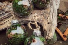 18 clear glass Christmas ornaments filled with moss, greenery, pinecones and cinnamon bark are amazing for woodland or rustic holiday decor