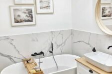 19 a small contemporary bathroom with a white marble backsplash and white furniture plus a gallery wall