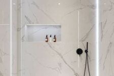 20 a minimalist white bathroom fully clad with marble, with a tub and a shower plus built-in lights for a refined feel