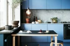 23 a blue minimalist kitchen with a grey marble backsplash and a black dining set for a gorgeous look