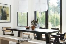 23 a bold dining zone with a view, a black dining table and chairs, a whitewashed bench and a light-stained floor