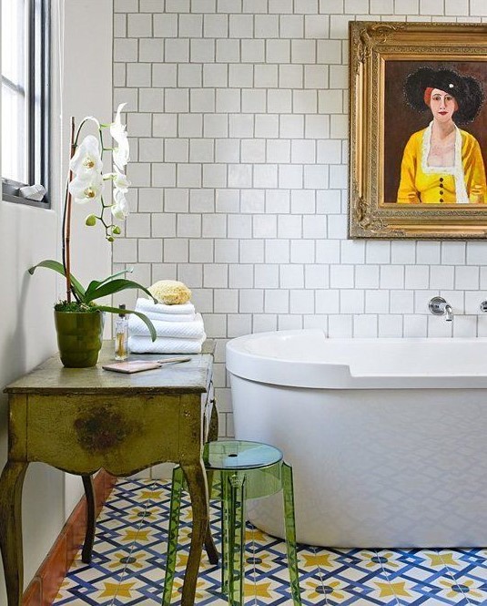 bold blue and yellow mosaic tiles on the floor set the tone in the bathroom, and white tiles on the wall just calm them down
