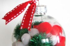 23 clear glass Christmas ornaments with red and white pompoms and green tinsel pieces, with red ribbon are fun and cool