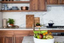 24 a rich-colored wooden kitchen contrasts the white marble backsplash and countertops and together they create a wow effect