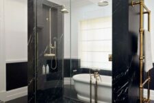 27 pure elegance and drama in this bathroom done with black marble, black penny tiles and a white vintage tub