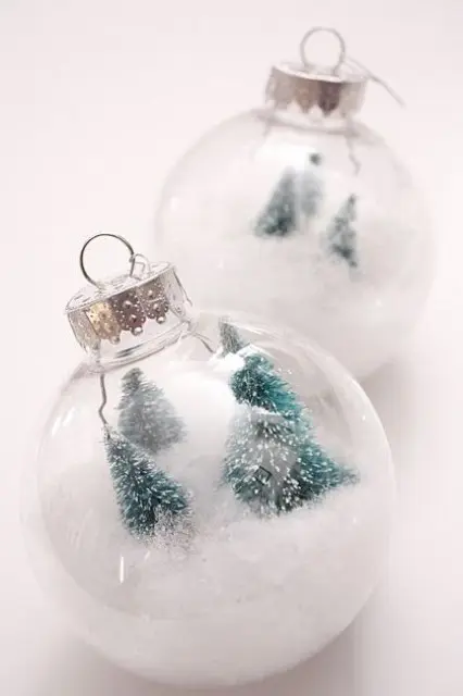 mini terrarium Christmas ornaments filled with faux snow and bottle brush Christmas trees are great for modern styling