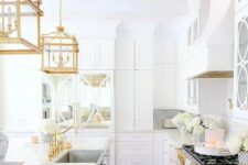34 a chic and glam white kitchen with gold fixtures, refined gold pendant lamps and gold handles is a very beautiful and refined idea