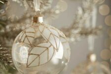 40 a clear glass Christmas ornament with white leaves and gold glitter accents are amazing for the holidays