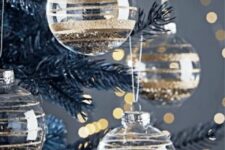 47 clear glass Christmas ornaments with gold glitter stripes and gold glitter inside are glam and chic