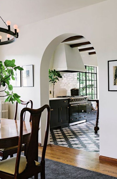 an arched doorway leading to the kitchen hints on vintage style and touches of Spanish colonial decor you'll see