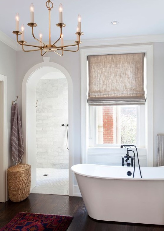 a contemporary bathroom with an arched doorway inviting to the shower space for more eye-catchiness