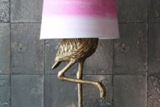 68 an antique bronze flamingo table lamp with a tie-dye pink lampshade for a touch of color to the space