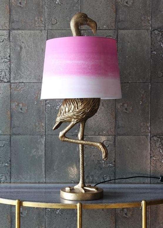 An antique bronze flamingo table lamp with a tie dye pink lampshade for a touch of color to the space