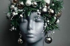a bust decorated with evergreens, snowy pieces and silver ornaments as a headpiece and earrings is a unique idea for Christmas