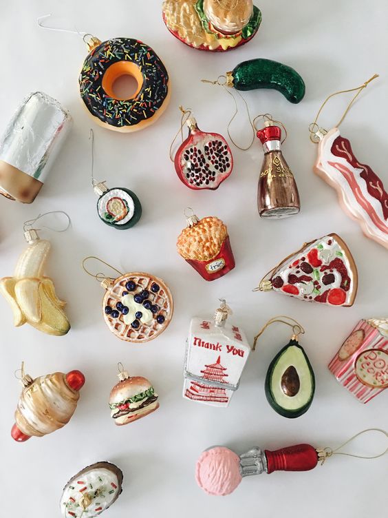 A collection of gorgeous foodie Christmas ornaments including pizza, waffles, a banana, a donut, ice cream, soy sauce and much other stuff