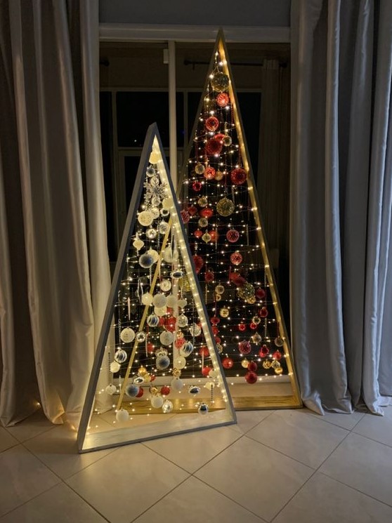 a duo of frame christmas tree with lights, white and silver and red and gold ornaments is a super creative solution for the holidays