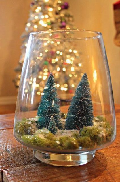 a glass Christmas terrarium with moss and three bottle brush trees is a cool idea and it's super easy to make yourself