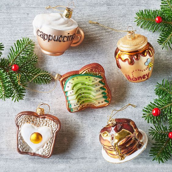 A gorgeous breakfast inspired Christmas ornament collection including an avocado toast, a cappuccino, a fried egg toast, pancakes and honey
