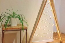 a minimalist double frame Christmas tree with lights inside and on a stand is a lovely and bold idea to rock