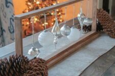 a simple wooden frame with a whole assortment of white and silver Christmas ornaments will be a nice DIY Christmas decoration