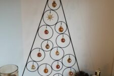 a tabletop metal frame Christmas tree with tiny copper and gold ornaments hanging is amazing for the holidays