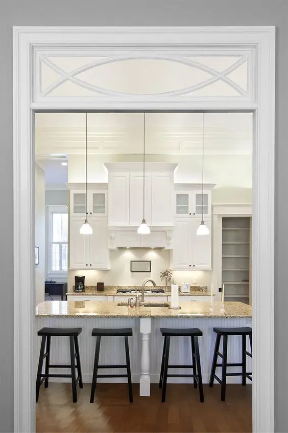 a traditional opening with a transom window that includes a pattern is a lovely and chic idea for a vintage space