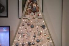 a whitewashed Christmas tree with lights, white and silver ornaments is a stylish tabletop decoration for the holidays