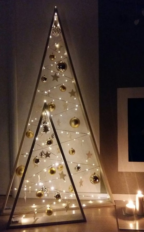 Beautiful frame Christmas trees with gold ornaments, stars and lights are amazing to give a touch of shine and an eye catchy look to your space