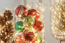 glass bowls with pinecones, evergreens and bold Christmas ornaments and lights are amazing to style your space for the holidays