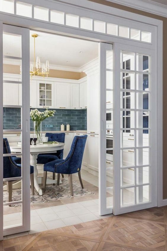sliding French doors and a transom window are a great combo for a space, they look chic and beautiful and highlight the vintage style
