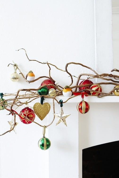 Vine like branches on the mantel with a whole assortment of beautiful Christmas ornaments will add a festive feel to the space