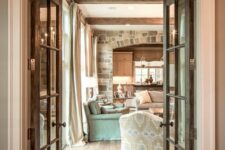 vintage stained doors plus a transom window add coziness to the space and highlight the barn and farmhouse style of the house