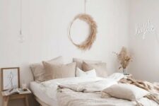 02 a beautiful modern boho bedroom with wooden furniture, a neon sign, a pampas grass wreath and neutral bedding