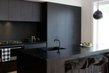 06 a contemporary black kitchen with sleek cabinets, a wooden kitchen island, stools with faux fur and a pendant lamp